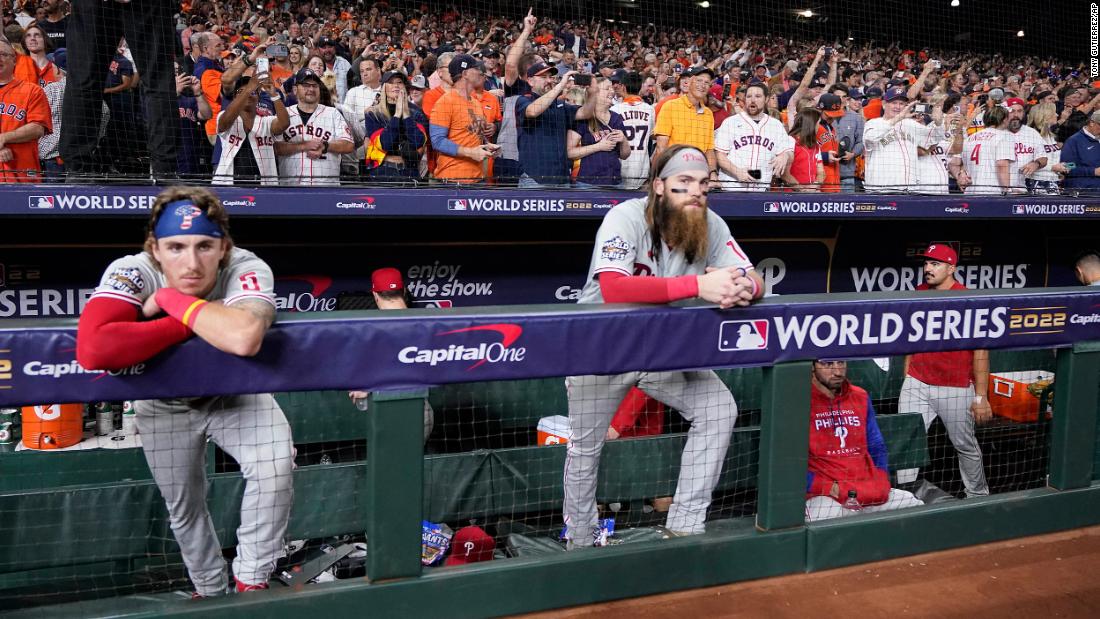 Phillies players watch the Astros celebrate.