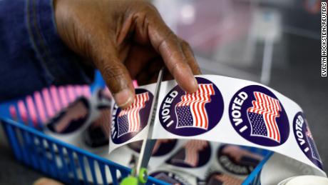 A poll worker prepares &quot;I voted&quot; stickers for voters at the City Clerk&#39;s Office ahead of the midterm election in Lansing, Michigan, U.S., November 7, 2022.