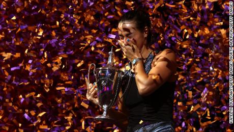 Garcia celebrates with the WTA Finals trophy after beating Aryna Sabalenka. 