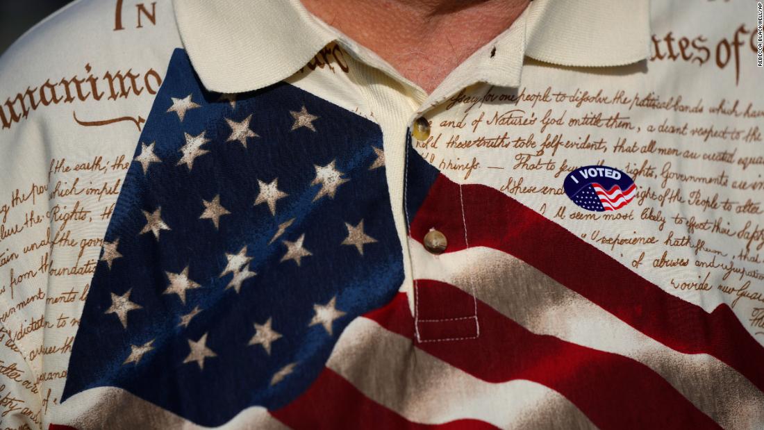 A man wears an &quot;I voted&quot; sticker on his shirt in Fort Myers, Florida.