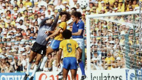 Italian forward Francesco Graziani tries to get to the ball with his head, but Brazil&#39;s goalkeeper Valdir Peres, assisted by his defender Oscar, punches the ball away.