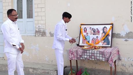 A grieving relative offers his respects to the 12 members of the Bodha family who died.