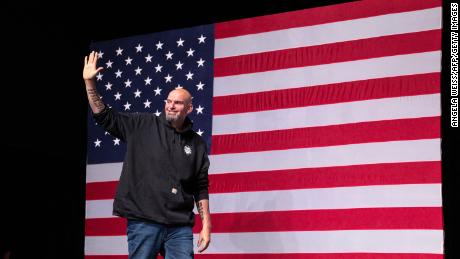 John Fetterman waves as he arrives onstage at a watch party during the midterm elections at Stage AE in Pittsburgh, Pennsylvania, on November 8, 2022. 