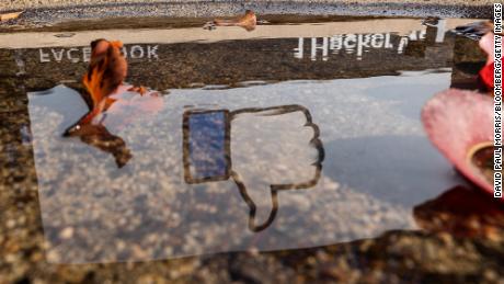 The Facebook logo reflected in a puddle at the company&#39;s headquarters in Menlo Park, California, U.S., on Monday, Oct. 25, 2021. 