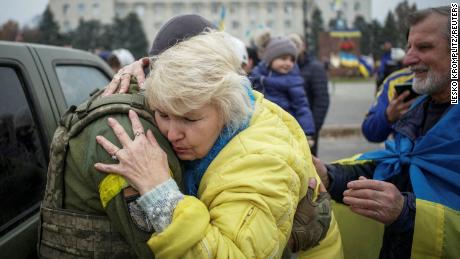 A local resident hugs a Ukrainian serviceman as people celebrate after Russia&#39;s retreat from Kherson city, in central Kherson, Ukraine, on November 12, 2022.