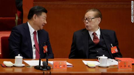 Chinese leader Xi Jinping talks to former leader Jiang Zemin during the Communist Party National Congress in Beijing on October 24, 2017. 