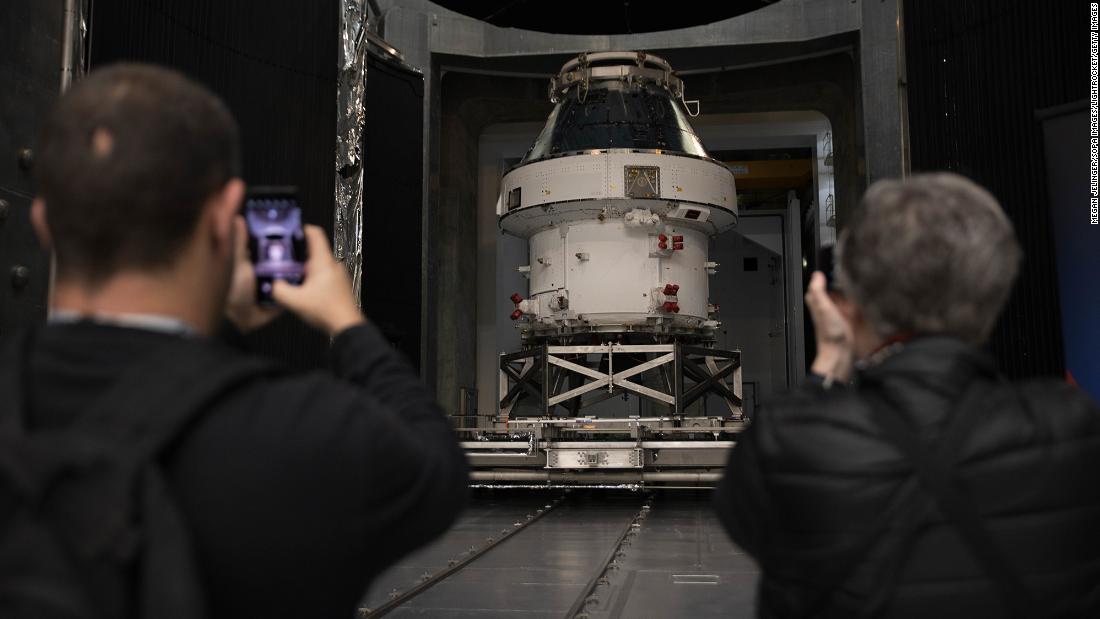 Spectators take photos at the unveiling of the Orion spacecraft for Artemis I at NASA&#39;s Plum Brook Station in Sandusky, Ohio, on March 14, 2020.