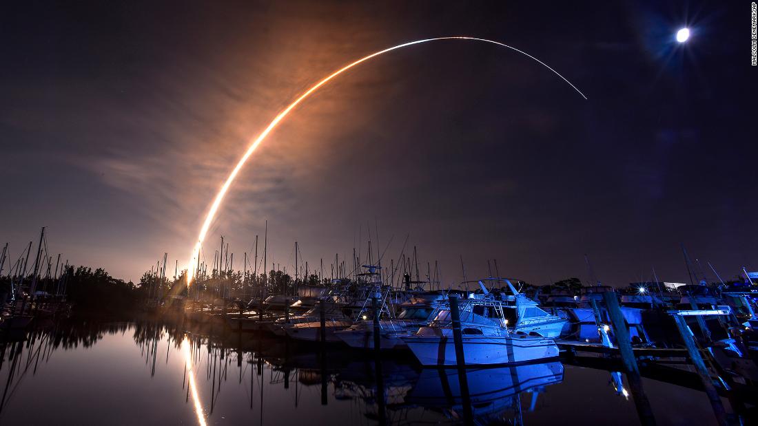 The Artemis I rocket lifts off through the night sky, seen in this long-exposure photograph taken from Merritt Island, Florida.
