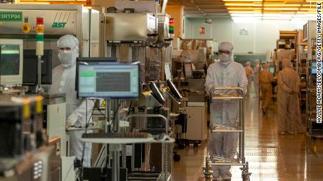 Workers in the clean room for silicon semiconductor wafer manufacturing at Newport Wafer Fab, owned by Nexperia, in Newport, UK, on Aug. 18, 2022. 