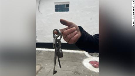 A former prisoner holds up the keys to the central prison in Kherson after the city was liberated by Ukrainian forces.