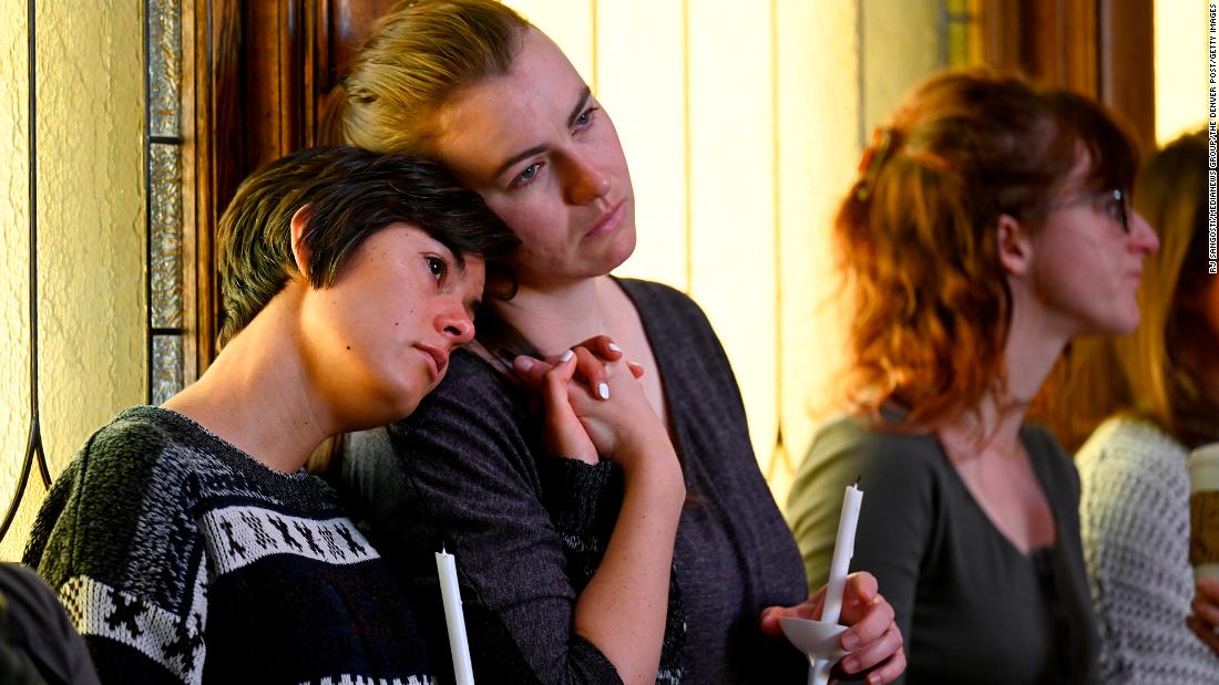 Sophia Diana, left, holds her friend Lex Chapman&#39;s hand during the vigil at the All Souls Unitarian Church.