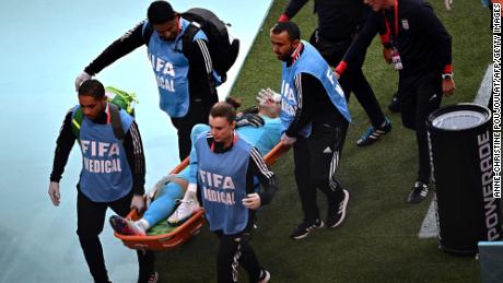 Iran&#39;s goalkeeper Alireza Beiranvand leaves the pitch on a stretcher after he was injured in a crash on heads with Iran&#39;s defender #19 Majid Hosseini during the game against England.