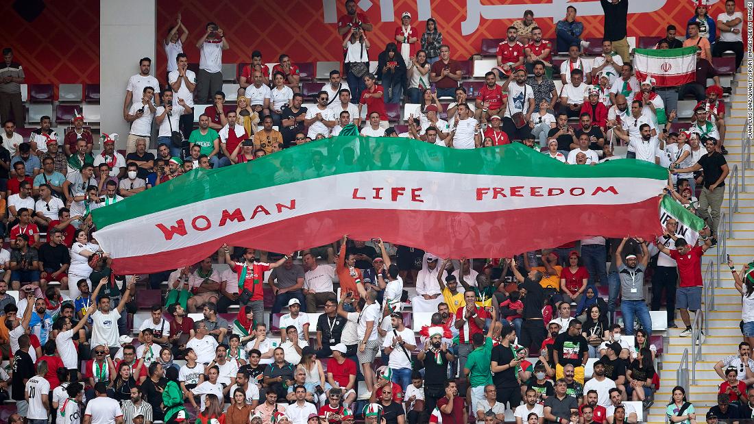 Iranian fans hold up a sign that reads &quot;Woman Life Freedom&quot; during the match against England. Anti-government protests have entered a third month back in Iran. Outside the stadium before the game, CNN witnessed a number of Iran supporters &lt;a href=&quot;https://www.cnn.com/sport/live-news/world-cup-11-21-22/h_64af1374bbf15fe3487b65c05d1b99b1&quot; target=&quot;_blank&quot;&gt;wearing protest T-shirts&lt;/a&gt;, with slogans such as &quot;Free Iran&quot; or &quot;Rise with the women of Iran.&quot;