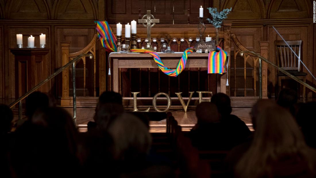 A Pride flag wraps around the altar during a vigil Monday at First Congregational Church in Colorado Springs.