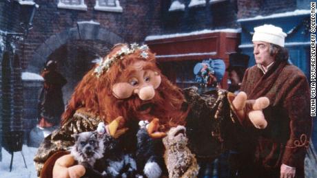 The Ghost of Christmas Present, left, and Michael Caine, right, in 1992&#39;s &quot;The Muppet Christmas Carol.&quot;