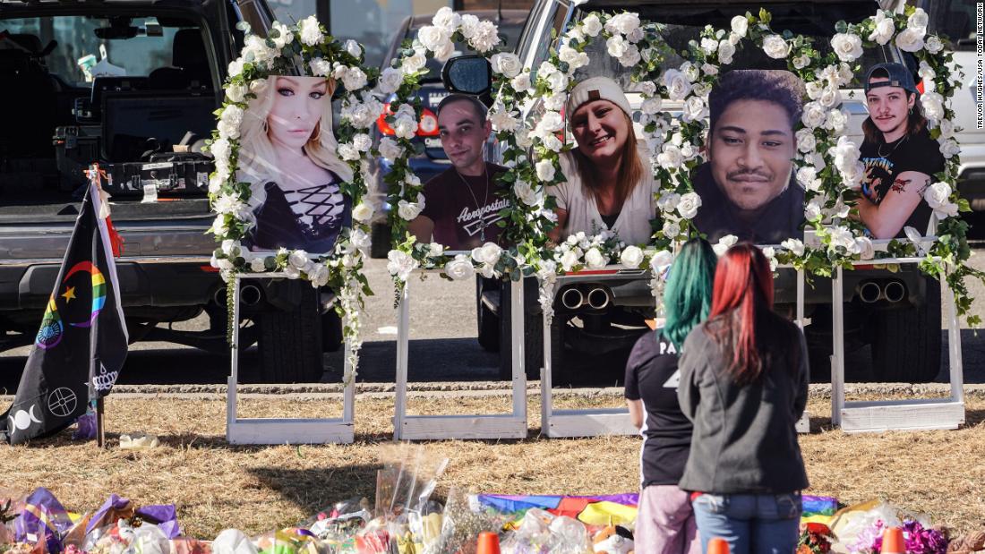 People pay their respects at a memorial display set up to remember the five victims of the Club Q shooting in Colorado Springs, Colorado, on Tuesday, November 22. 