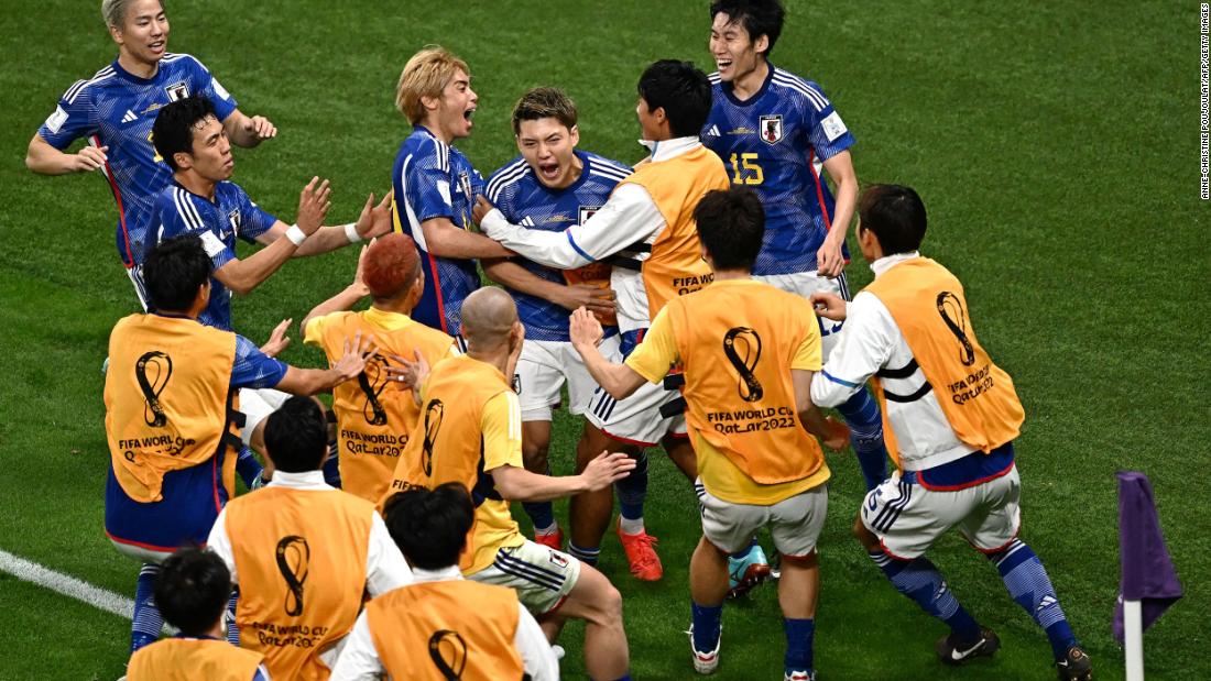 Japan midfielder Ritsu Doan, center, is mobbed by teammates after scoring the team&#39;s first goal against Germany on November 23. Japan went on to win 2-1.