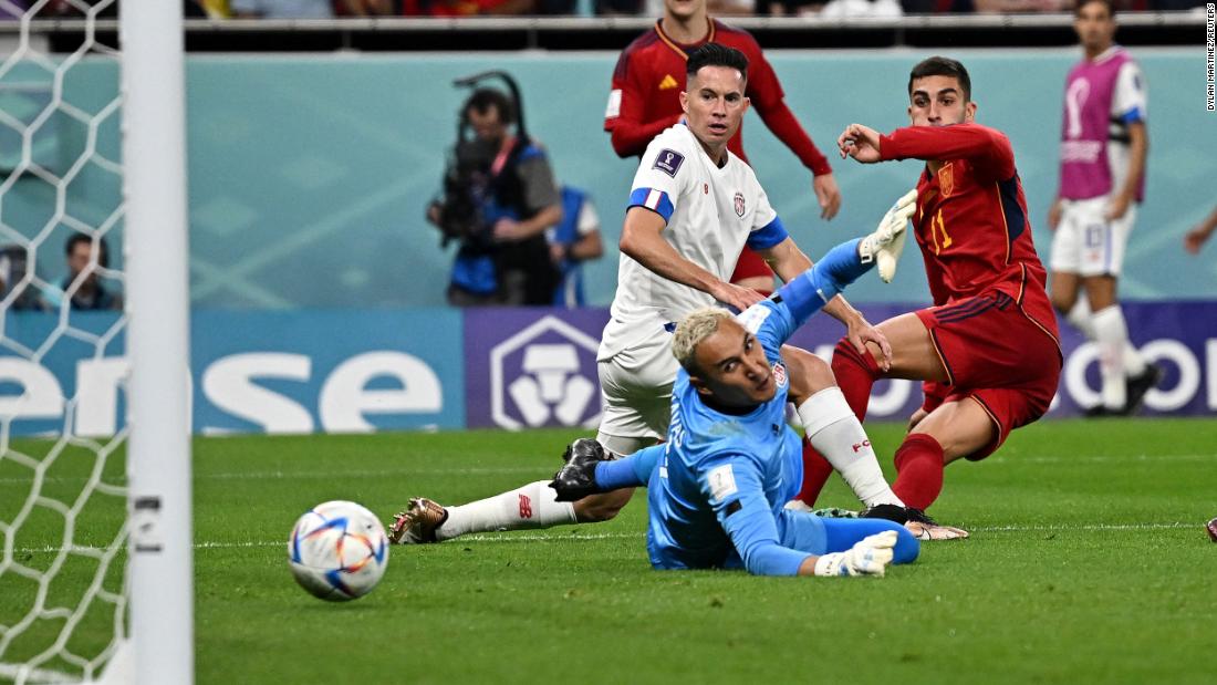 Spain&#39;s Ferran Torres, right, shoots past Costa Rican goalkeeper Keylor Navas to give his team a 4-0 lead in their opening match on November 23. Spain went on to win 7-0.