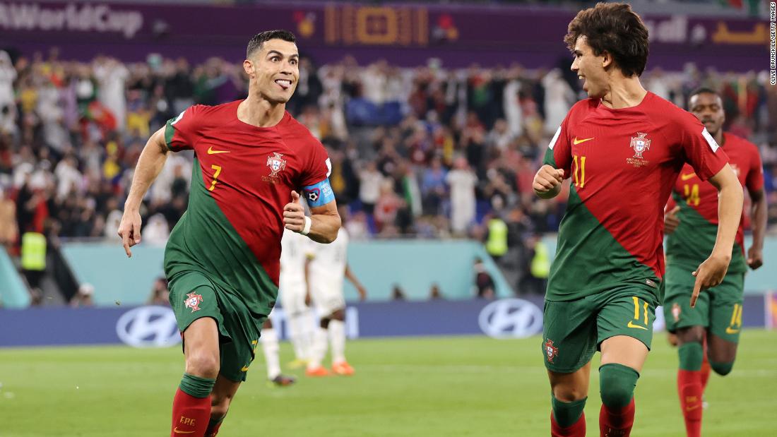 Ronaldo makes a face as he celebrates his goal with teammate João Félix.