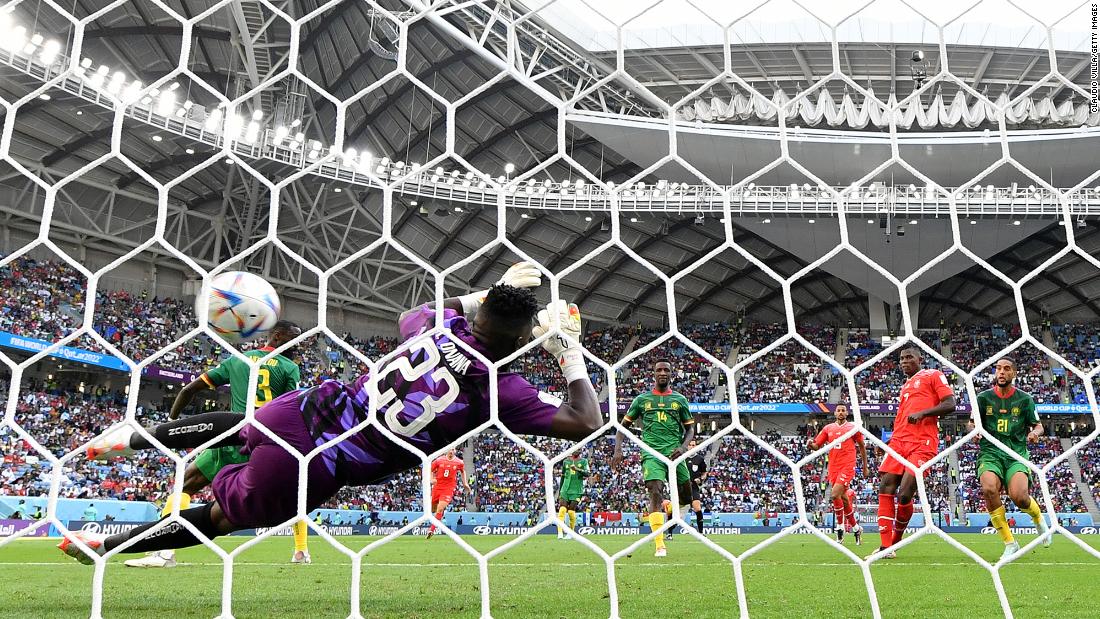 Switzerland&#39;s Breel Embolo, second from right, shoots past Cameroon&#39;s Andre Onana to score the only goal of their match.