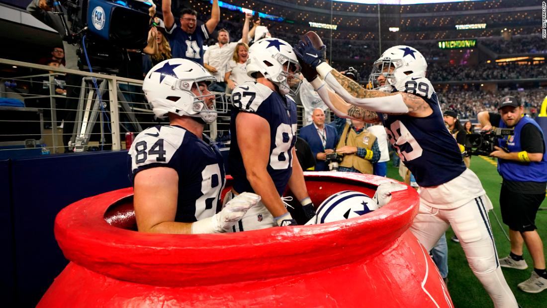 Dallas&#39; Peyton Hendershot, right, celebrates a touchdown with teammates inside a big Salvation Army kettle during the Cowboys&#39; Thanksgiving Day win over the New York Giants on Thursday, November 24.