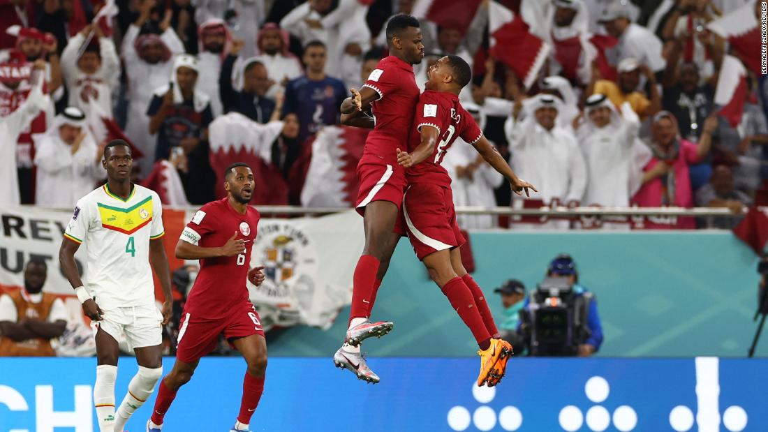 Mohammed Muntari, center, celebrates after scoring Qatar&#39;s first-ever World Cup goal. Muntari headed home a cross in the 78th minute to cut Senegal&#39;s lead to 2-1.