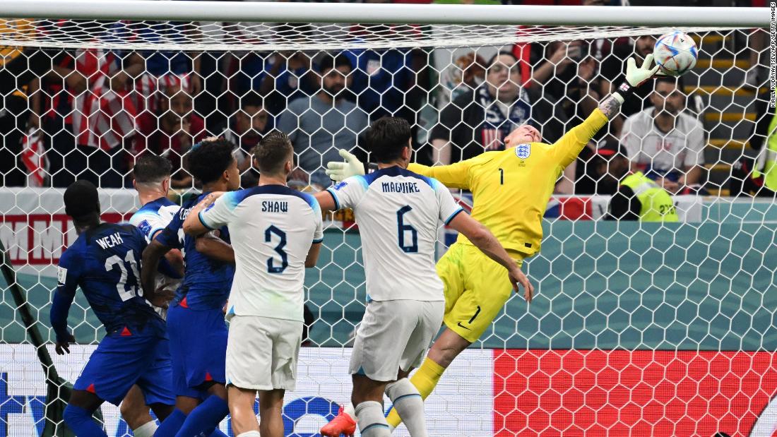 England goalkeeper Jordan Pickford dives to make a save in the match against the United States.