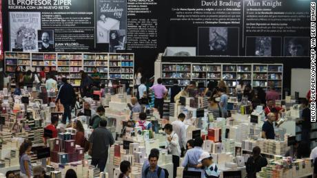 Visitors look at books during the first day of the International Book Fair in Guadalajara, Mexico, on November 28, 2015. This year the guest of honor at the fair is the United Kingdom. AFP PHOTO/HECTOR GUERRERO / AFP / HECTOR GUERRERO        (Photo credit should read HECTOR GUERRERO/AFP via Getty Images)