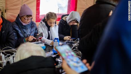 Residents of Kherson charge their phones in a tent provided by the local administration.
