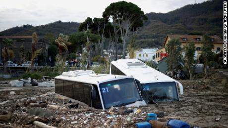 The landslide left damaged buses among the debris. 