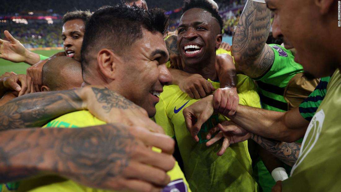 Brazilian midfielder Casemiro, front left, is mobbed by teammates after scoring against Switzerland.