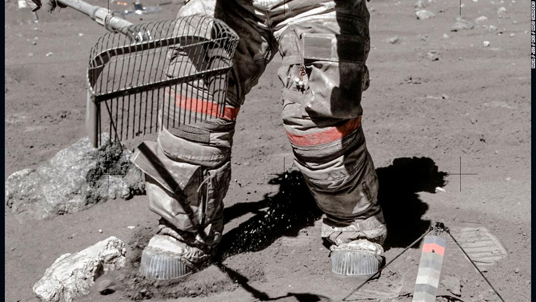 Commander John Young rakes for samples during Apollo 16&#39;s 71-hour stay on the surface of the moon in April 1972.
