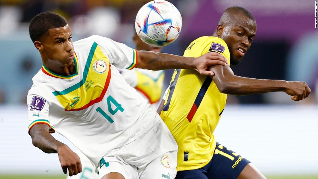 Senegal&#39;s Ismail Jakobs, left, tries to fend off Ecuador&#39;s Enner Valencia on November 29.