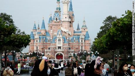 Tourists visit the Enchanted Storybook Castle at the Shanghai Disney Resort on the reopening day after a temporary closure for COVID-19 control on November 25, 2022 in Shanghai, China.
