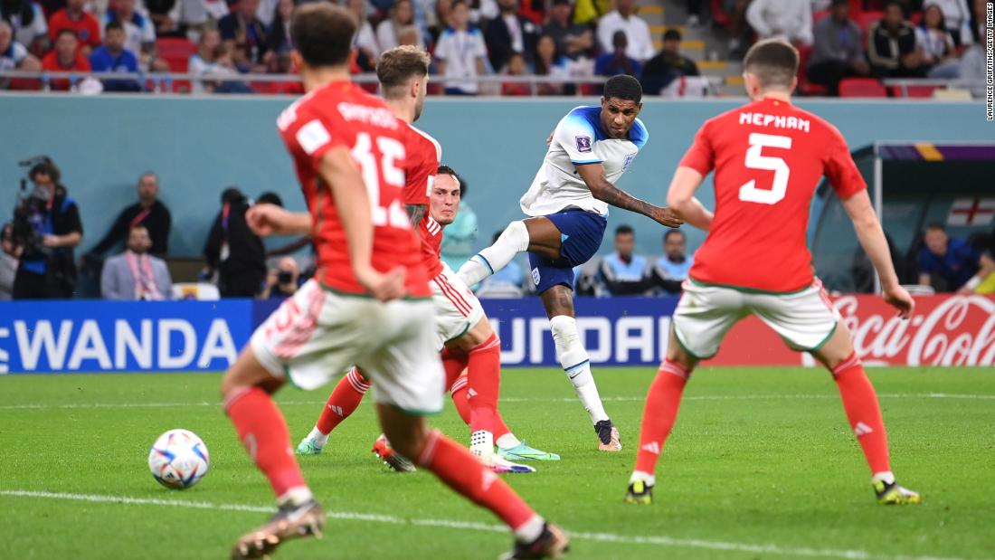 Marcus Rashford scores England&#39;s third goal against Wales. He had two goals in the match.