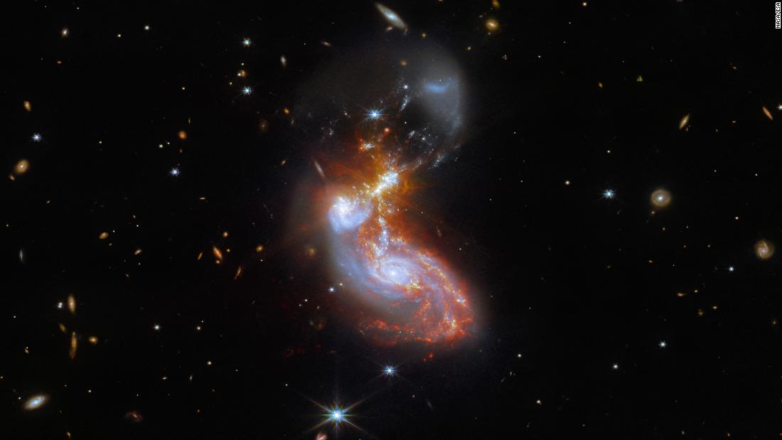 Two galaxies, known as II ZW96, form a swirl shape while merging in the constellation Delphinus.