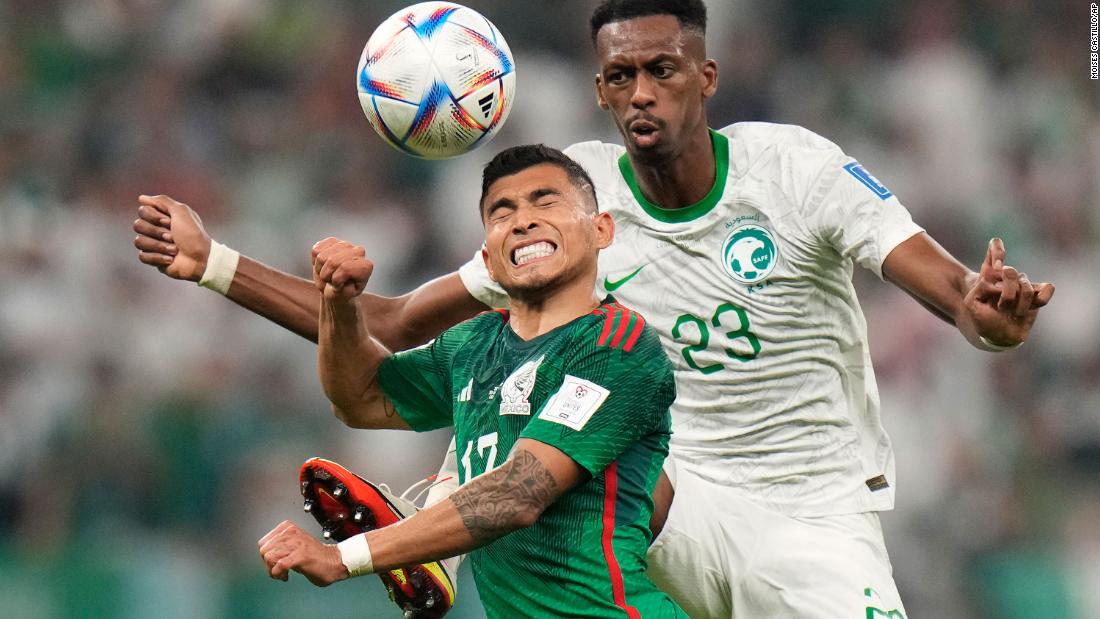 Mexico&#39;s Orbelín Pineda, left, and Saudi Arabia&#39;s Mohamed Kanno go for a header during their match on November 30. Mexico won 2-1.
