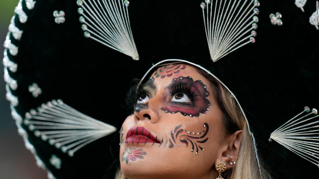 A fan wears La Catrina-style makeup at the start of the Mexico-Saudi Arabia match.