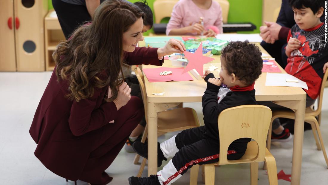 Kate talks to a child Thursday while visiting Roca, a nonprofit organization.