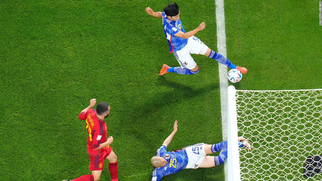 Japan&#39;s Kaoru Mitoma passes the ball near the goal line, leading to a goal &lt;a href=&quot;https://www.cnn.com/sport/live-news/world-cup-2022-12-01-2022/h_e4ab2ec63f6820b9a3c4924c34bc0f36&quot; target=&quot;_blank&quot;&gt;that was upheld by a video assistant referee (VAR) review&lt;/a&gt; during the match against Spain on December 1. Japan took a 2-1 lead and held on to win by that score. It finished first in Group E while Spain finished second.