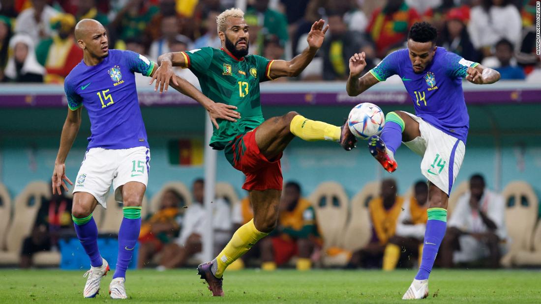 Cameroon&#39;s Eric Maxim Choupo-Moting tries to bring the ball down between Fabinho and Éder Militão.