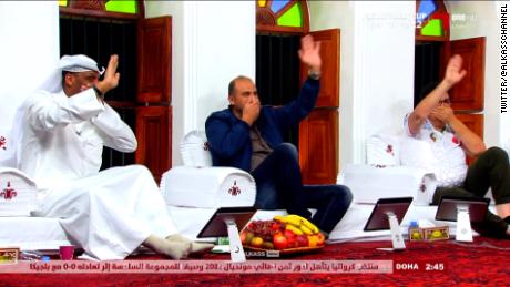 Football pundits on Qatar&#39;s Alkass Sports channel appear to mimic the German players&#39; protest gesture.