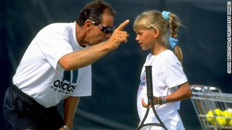 Bollettieri gives instructions to a young Anna Kournikova during a training session at his Tennis Academy in Bradenton, Florida.