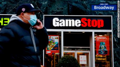 A man talks by his phone in front of GameStop at 6th Avenue on February 25, 2021 in New York. 
