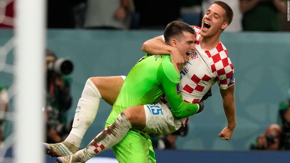Mario Pasalic, right, celebrates with goalkeeper Dominik Livaković after Croatia won a penalty shootout over Japan. Livaković made three saves in the shootout after the match ended 1-1.