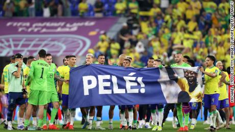 Brazil players hold a banner showing support for former Brazil player Pele after the FIFA World Cup Qatar 2022 Round of 16 match between Brazil and South Korea on December 5. 