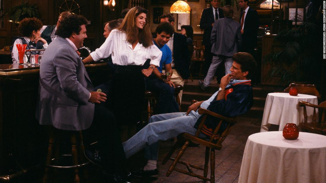 George Wendt, Alley, and Ted Danson in a scene in the hit NBC TV show &quot;Cheers.&quot; Alley, who joined the cast in 1987, played the role of Rebecca Howe, which catapulted her to stardom. 