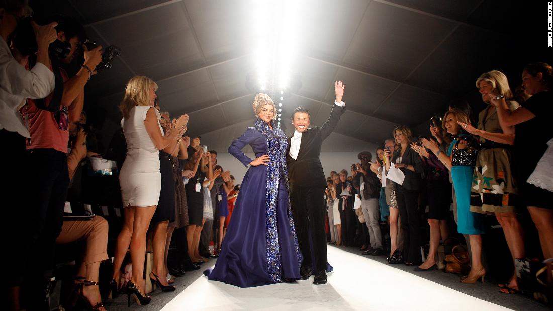 Alley embraces fashion designer Zang Toi after walking the runway at the Zang Toi show during New York Fashion Week in 2011.
