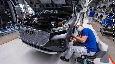 An employee works in the wheel arch of an Audi Q4 e-tron electric vehicle (EV) on the assembly line at the Volkswagen AG (VW) electric automobile plant in Zwickau, Germany, on Tuesday, April 26, 2022. The Zwickau assembly lines are the centerpiece of a plan by VW, the world&#39;s biggest automaker, to manufacture as many as 330,000 cars annually. Photographer: Krisztian Bocsi/Bloomberg via Getty Images
