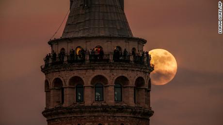 The last full moon of the year known as the Cold Moon rises behind Galata tower in Istanbul, Turkey, Wednesday, Dec. 7, 2022. (AP Photo/Emrah Gurel)